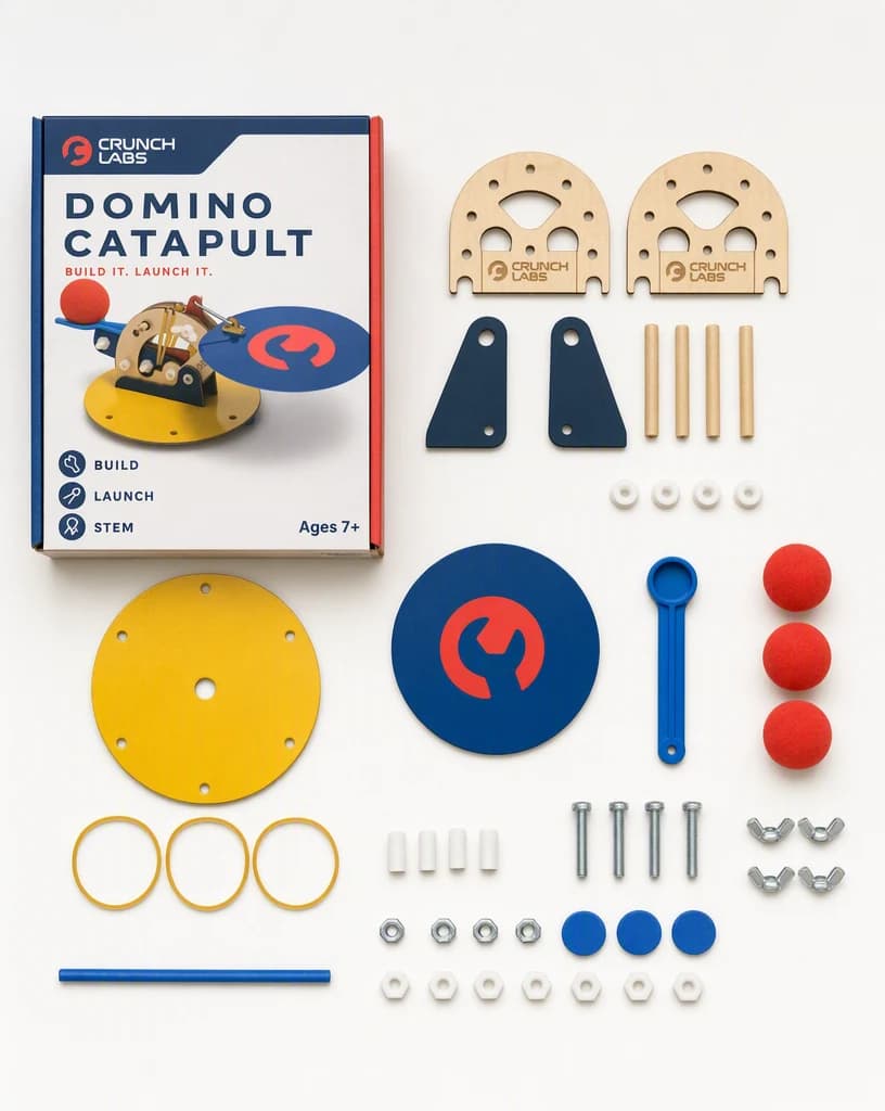 A catapult build kit laid out top down with every wood piece, gear, bolt, and part separated and countable beside its packaging.